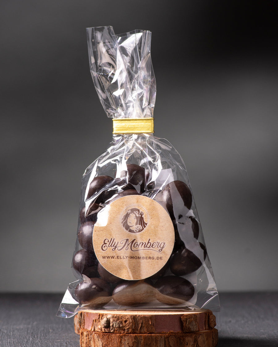 Bag of chocolate covered almonds in clear packaging with a visible brand label on a dark background