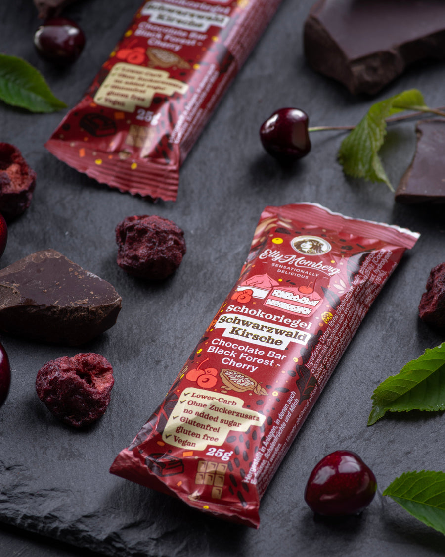 Chocolate gourmet bar with a cross-section on a dark surface with cherry black forest, sugar free, vegan, gluten free, keto. lower carb, diabetics