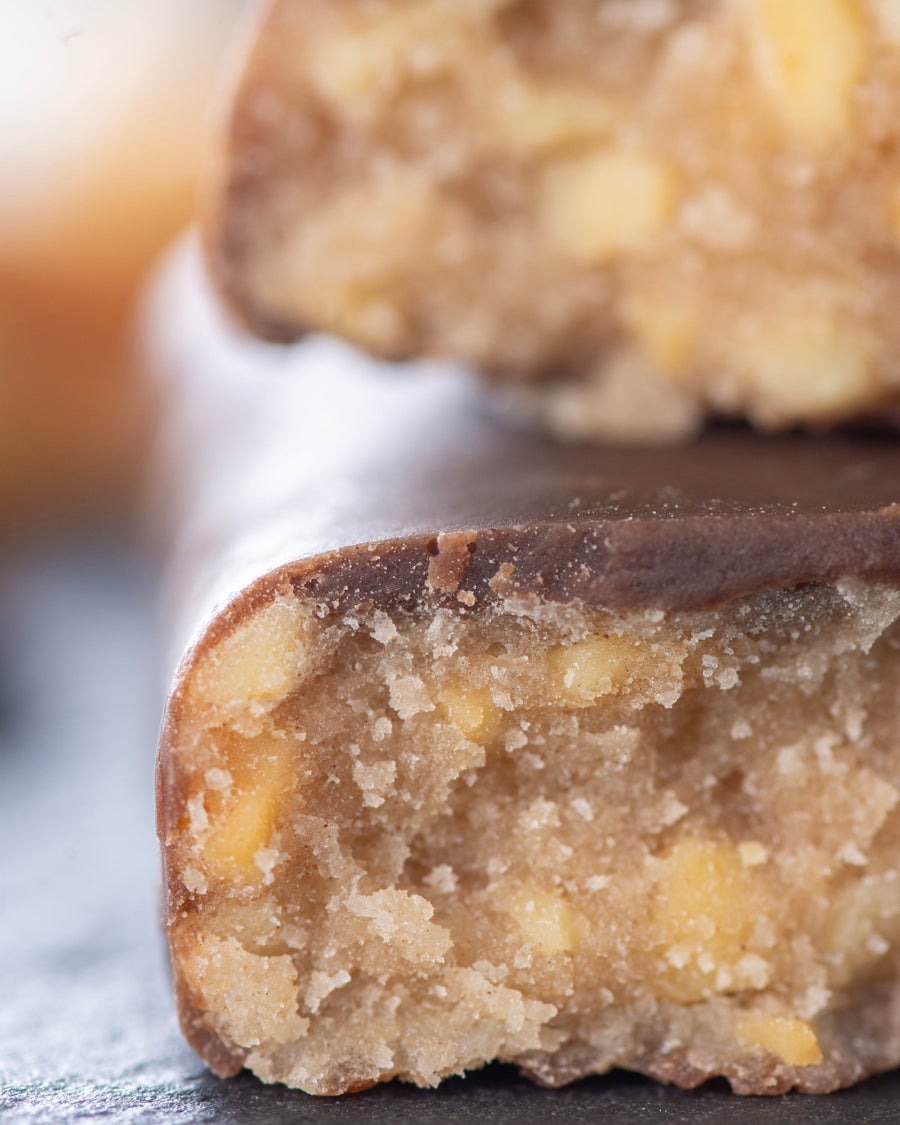 Chocolate peanut caramel gourmet bar with a cross-section with peanuts, sugar free, no added sugar, vegan, gluten free, keto. lower carb, diabetics
