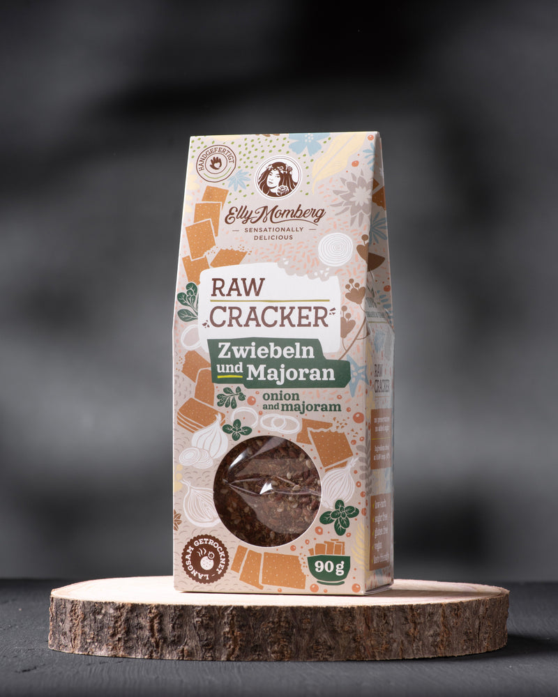 Package of raw crackers with herbs on a dark background