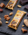 Chocolate peanut caramel gourmet bar with a cross-section with peanuts, sugar free, no added sugar, vegan, gluten free, keto. lower carb, diabetics