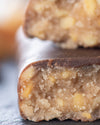 Chocolate peanut caramel gourmet bar with a cross-section with peanuts, sugar free, no added sugar, vegan, gluten free, keto. lower carb, diabetics
