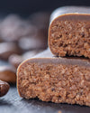 Chocolate bar with a cross-section on a dark surface with coffee beans, sugar free, vegan, gluten free, keto. lowert carb, diabetics