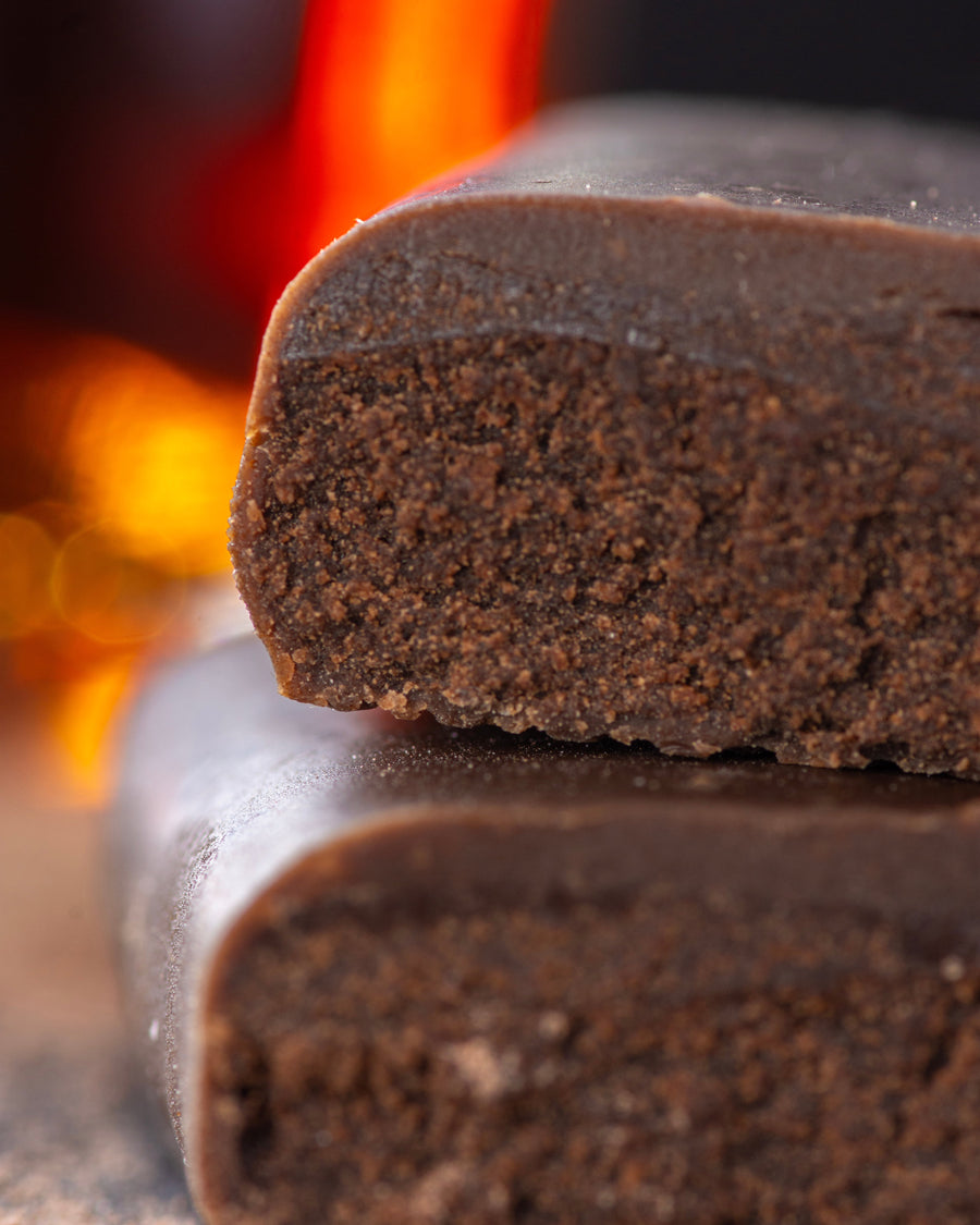 Chocolate gourmet bar with a cross-section on a dark surface with cocoa rum, sugar free, vegan, gluten free, keto. lowert carb, diabetics