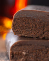 Chocolate gourmet bar with a cross-section on a dark surface with cocoa rum, sugar free, vegan, gluten free, keto. lowert carb, diabetics