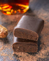 Chocolate gourmet bar with a cross-section on a dark surface with cocoa rum, sugar free, vegan, gluten free, keto. lowert carb, diabetics