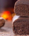 Chocolate gourmet bar with a cross-section on a dark surface with cocoa rum, sugar free, vegan, gluten free, keto. lowert carb, diabetics