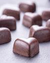 Chocolate candies on a textured surface